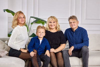 Portrait of happy friends sitting on sofa