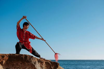 View of man in sea against clear sky