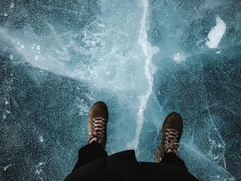 Low section of person on frozen sea