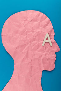 High angle view of paper painting on blue background