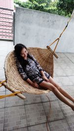 Young woman sitting on hammock