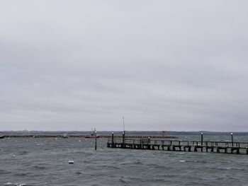 Pier over sea against sky