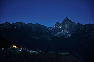 Scenic view of mountains against clear blue sky