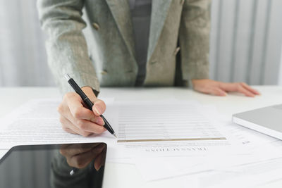 Midsection of businessman working at office