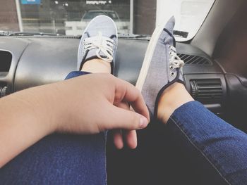 Low section of child sitting in car