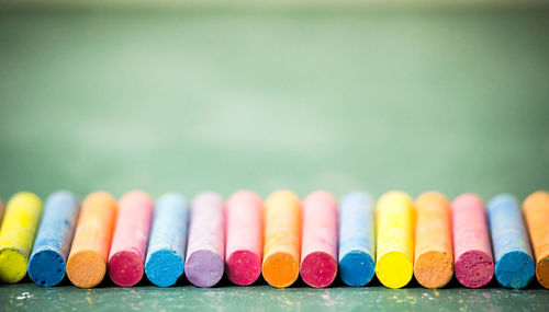 Close-up of colorful chalks arranged