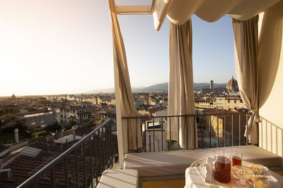 Cityscape against clear sky seen through balcony