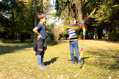 Full length of boys playing on plants