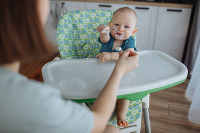 Close-up of baby boy washing hands in bathroom