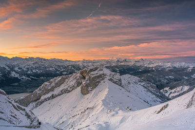 Scenic view of snowcapped mountains against sky during sunset