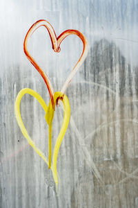 Graffiti hearts on bus stop glass