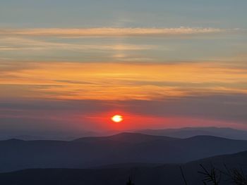Scenic view of silhouette mountains against sky during sunset