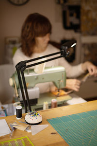Woman sewing fabric with a vintage, retro sewing machine. fashion, creation and tailoring. 