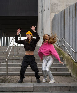 Full length of woman standing on steps