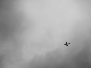 Low angle view of airplane flying in sky