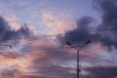 Low angle view of power lines against sky