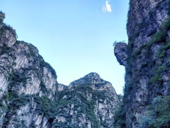 Low angle view of rock formation against sky