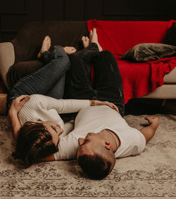 Young couple lying on floor at home