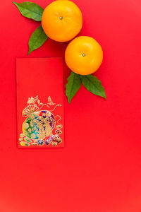 Close-up of orange fruits on red background