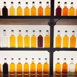 Multi colored bottles on shelf