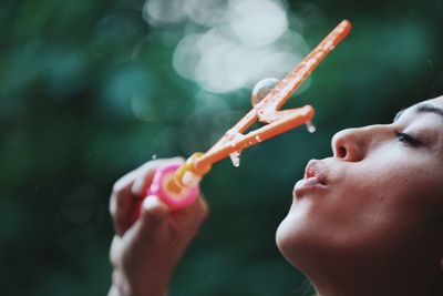 Close-up of woman holding bubble wand