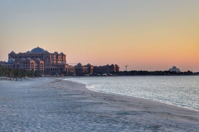 Scenic view of beach against clear sky during sunset