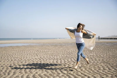 Full length of man on beach against sky