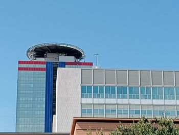 Low angle view of building against clear blue sky