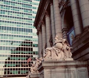 Low angle view of statue against historic building