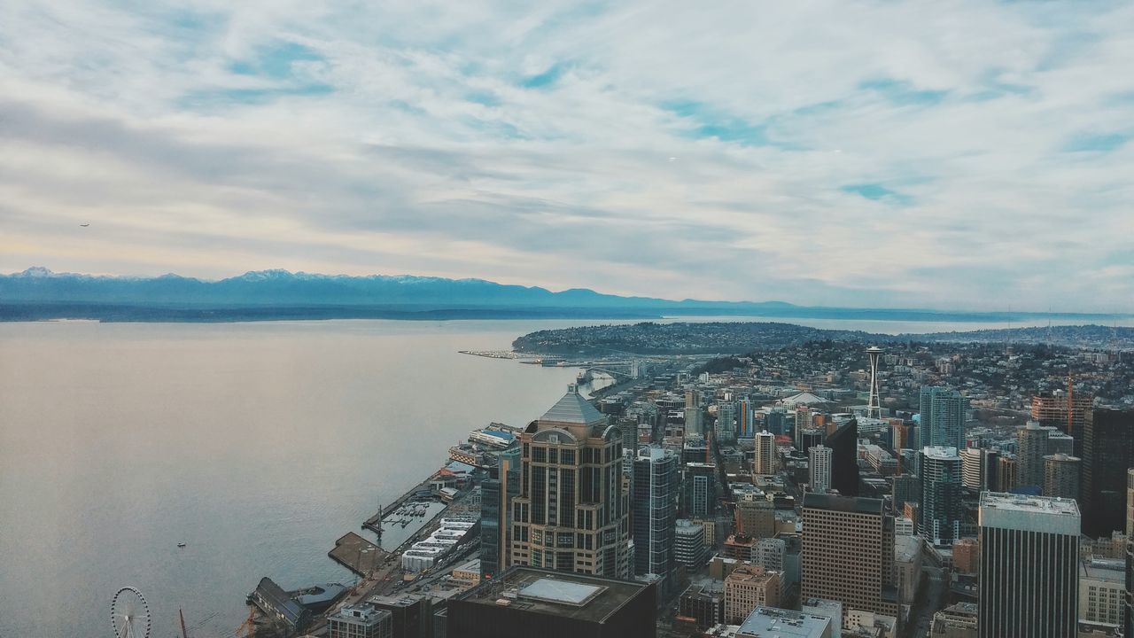 water, sky, sea, building exterior, architecture, city, built structure, cityscape, cloud - sky, high angle view, beach, cloud, cloudy, shore, nature, day, coastline, outdoors, skyscraper, crowded