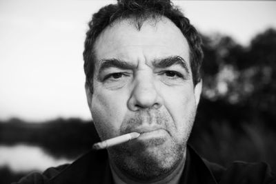 Portrait of man smoking cigarette