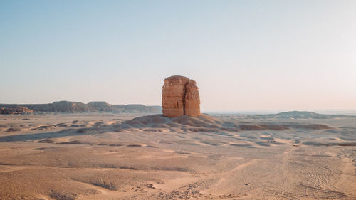 Rock formations in desert against clear sky