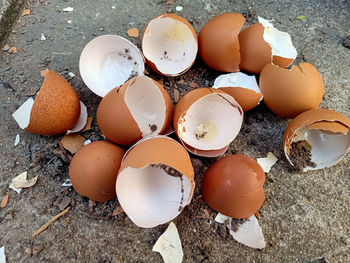 High angle view of broken eggs in container