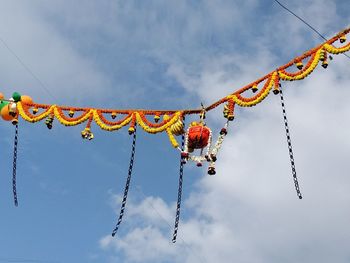 Low angle view of dahi handi decorations against sky
