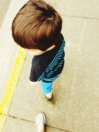 High angle view of boy standing on street