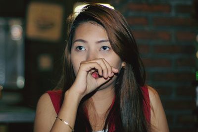 Close-up of woman looking away outdoors at night