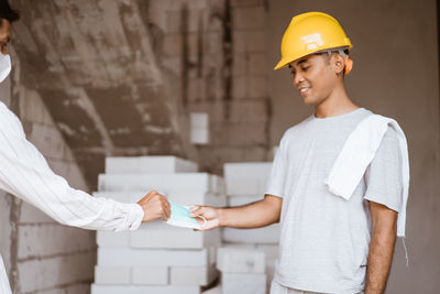 Man working with arms raised