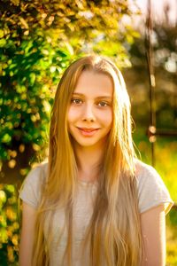 Portrait of smiling young woman standing outdoors