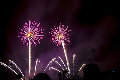 Low angle view of firework display at night