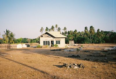 House on field against clear sky