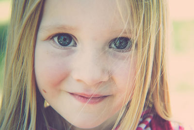 Close-up portrait of smiling young woman