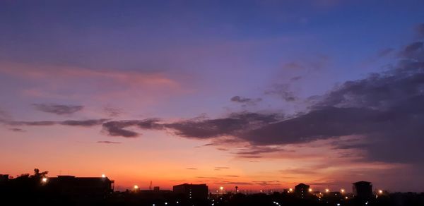 Silhouette buildings against sky during sunset