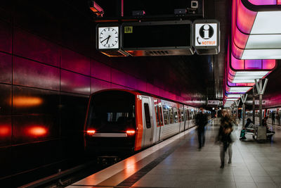 Train at railroad station platform at night