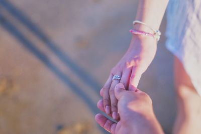 Close-up of woman and man holding hand