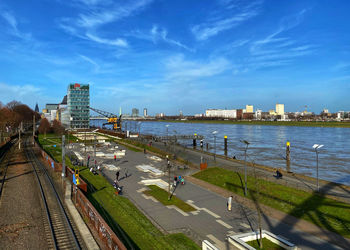 High angle view of buildings by river against sky