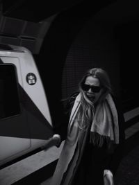 Woman standing against subway train