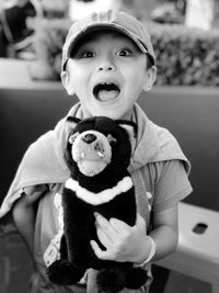 Portrait of cute boy with toy