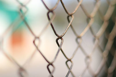 Close-up of chainlink fence against sky