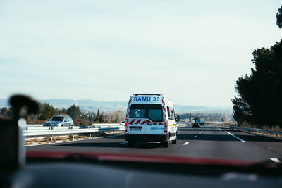 Cars on road against sky