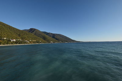 Scenic view of sea against clear blue sky